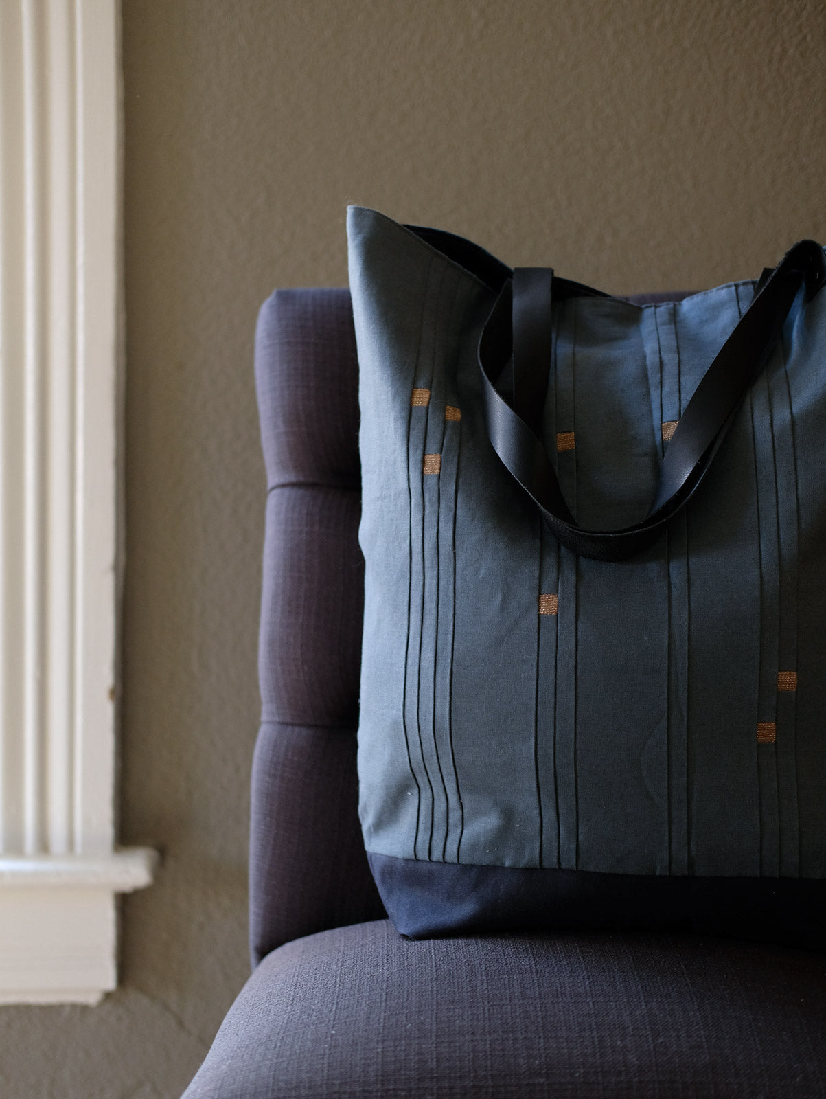 Constellations Star Sign Tote sitting on a chair near a window