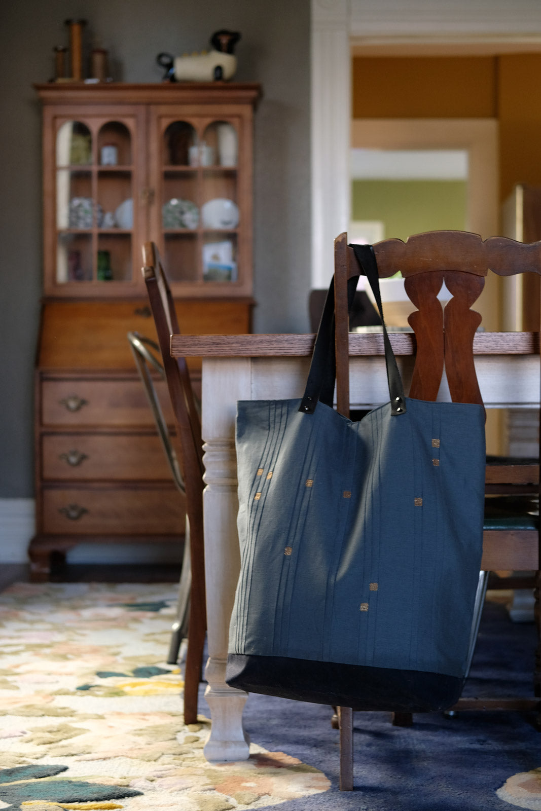 Star Sign Tote hanging in a chair in a dining room