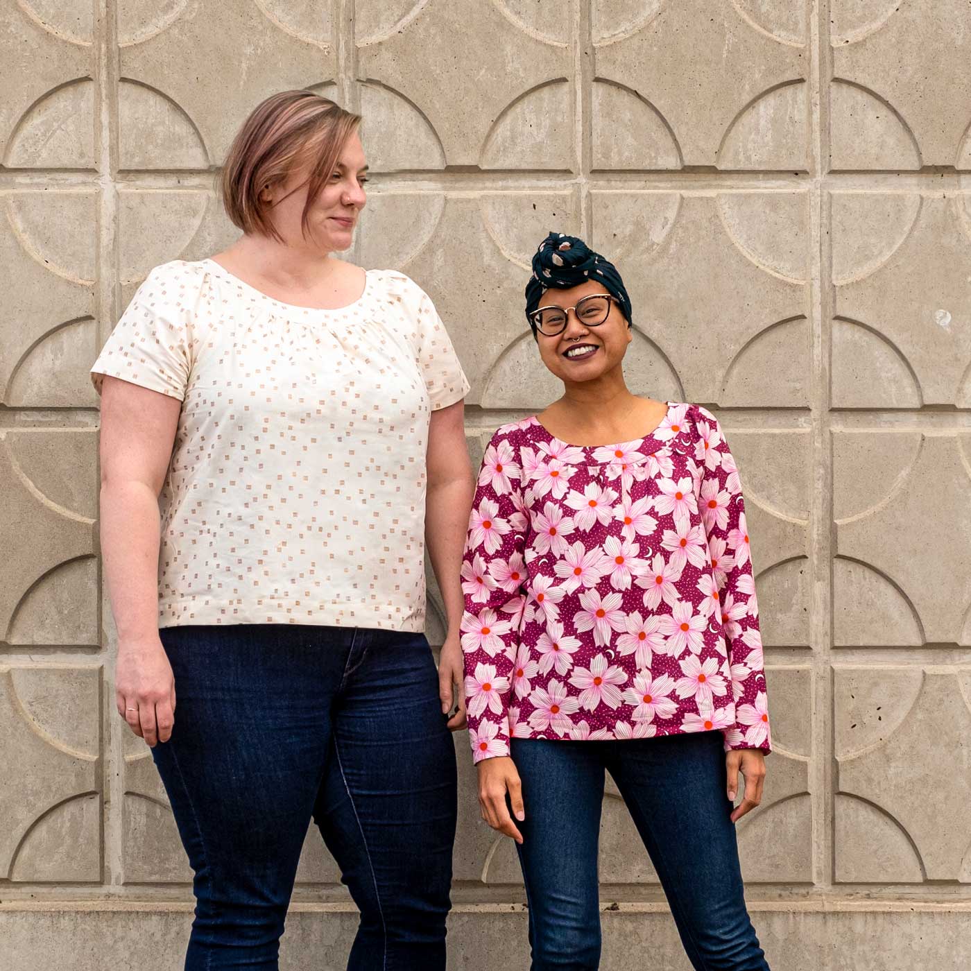 Kendra and Elyse wearing the Cordyline sewingpattern. Kendra wearing short sleeve top sewn in a white print with small copper mark pattern. Elyse is wearing a long sleeve magenta floral print. 