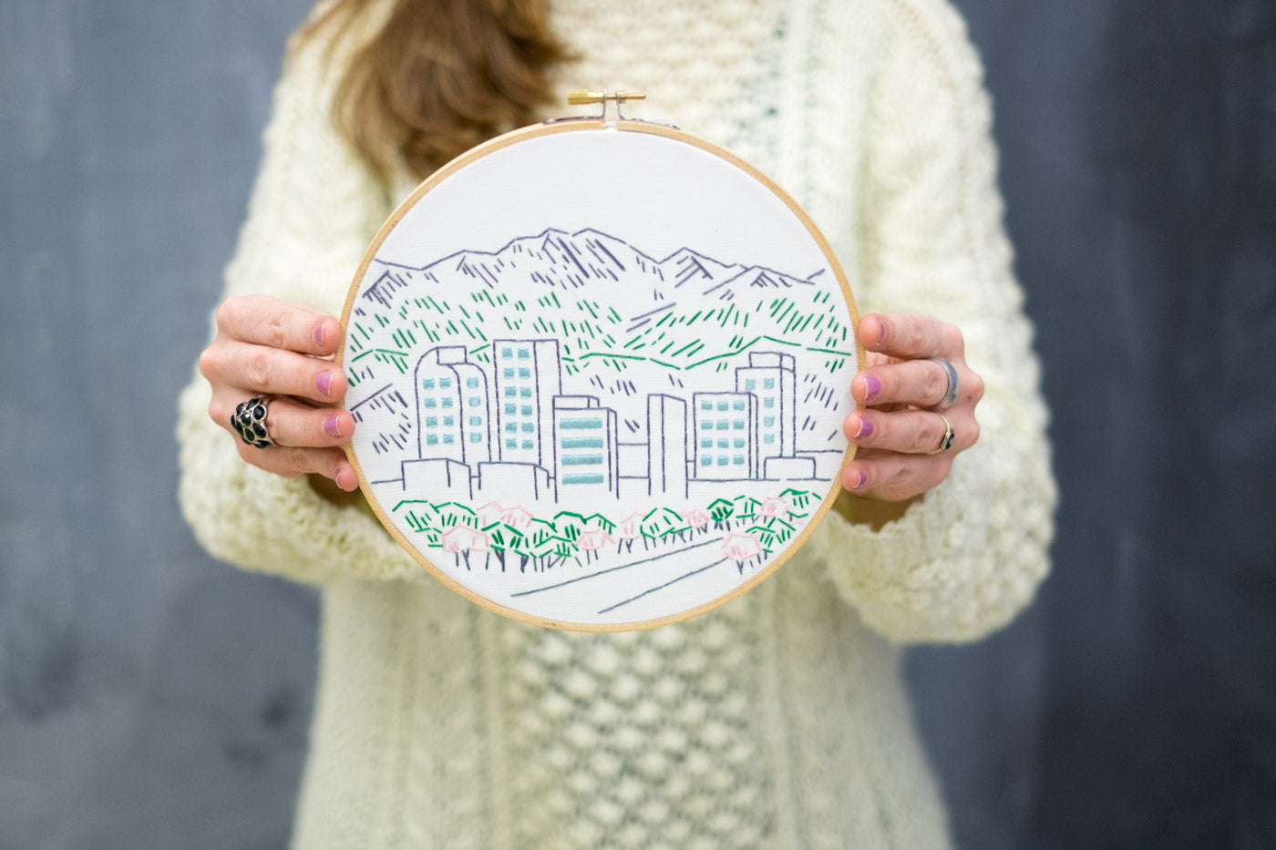 Kelly Holding Her Denver Skyline Embroidery