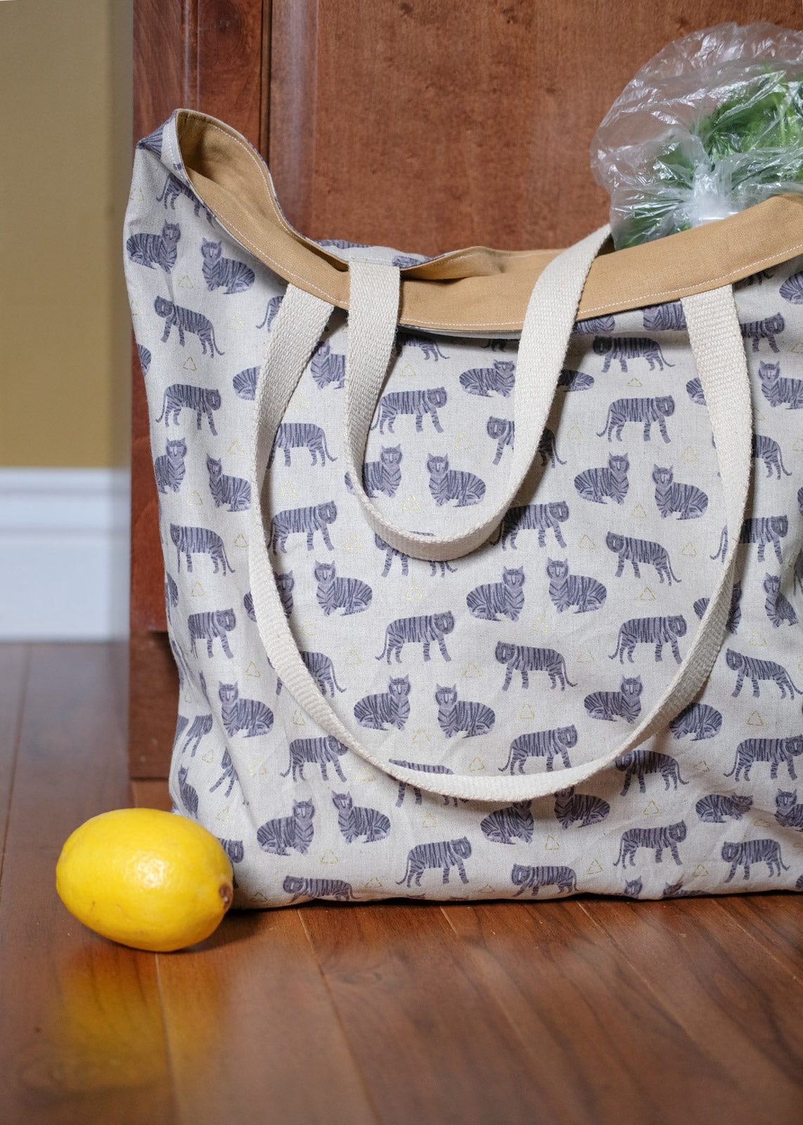 Fancy Tiger Crafts Market Tote sitting on the floor with a lemon in front