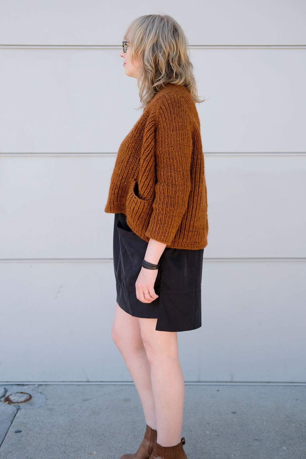 Side view of this boxy copper colored sweater