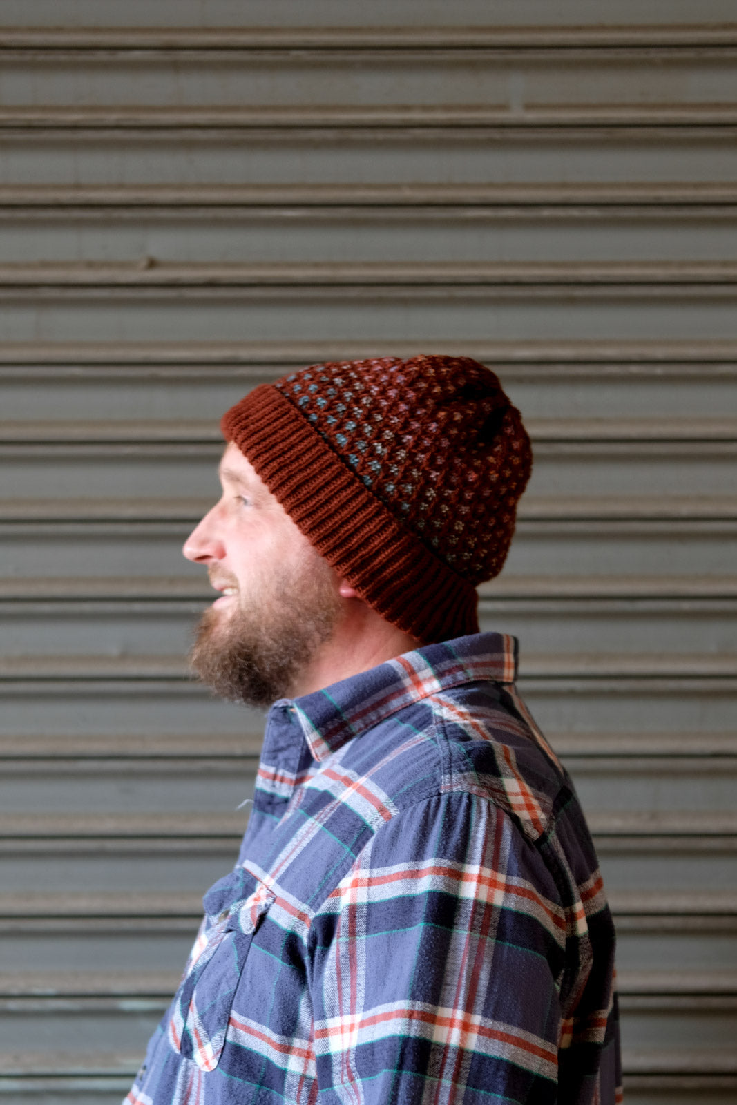 Side view of Scott's rusty red Honey Drudger hat