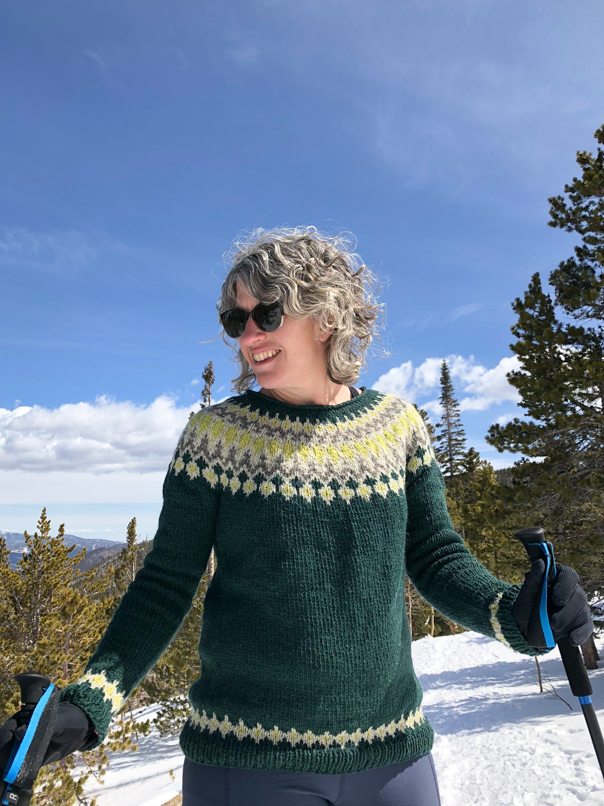 Close up of Jaime holding her hiking poles in her Navia Treysta sweater