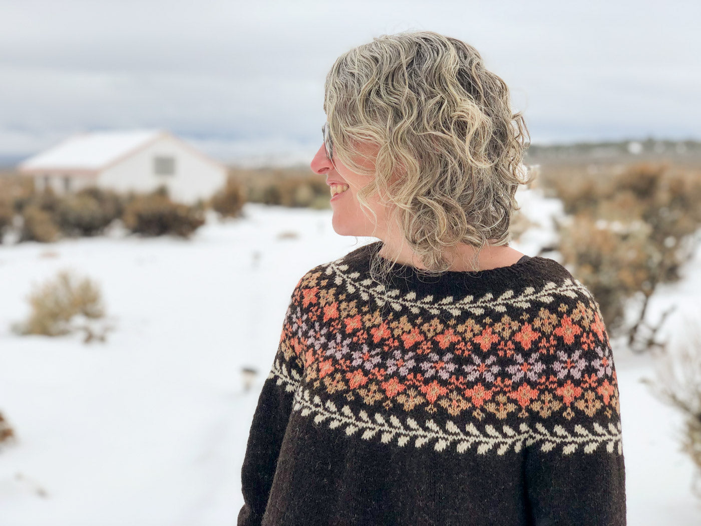 Jaime in the snowy plains wearing her Birkin Sweater
