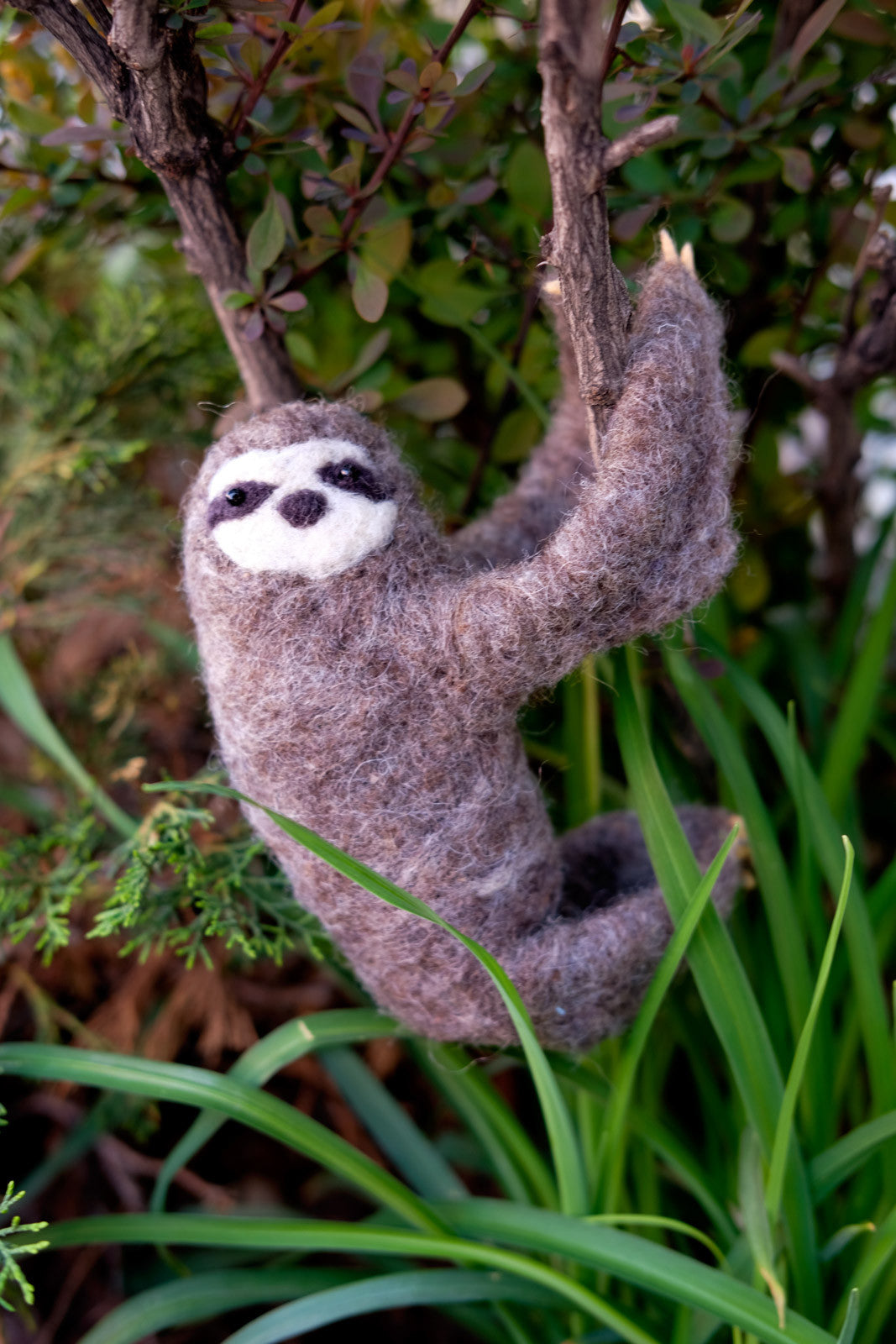 Needle Felted Sloth hanging in a bush