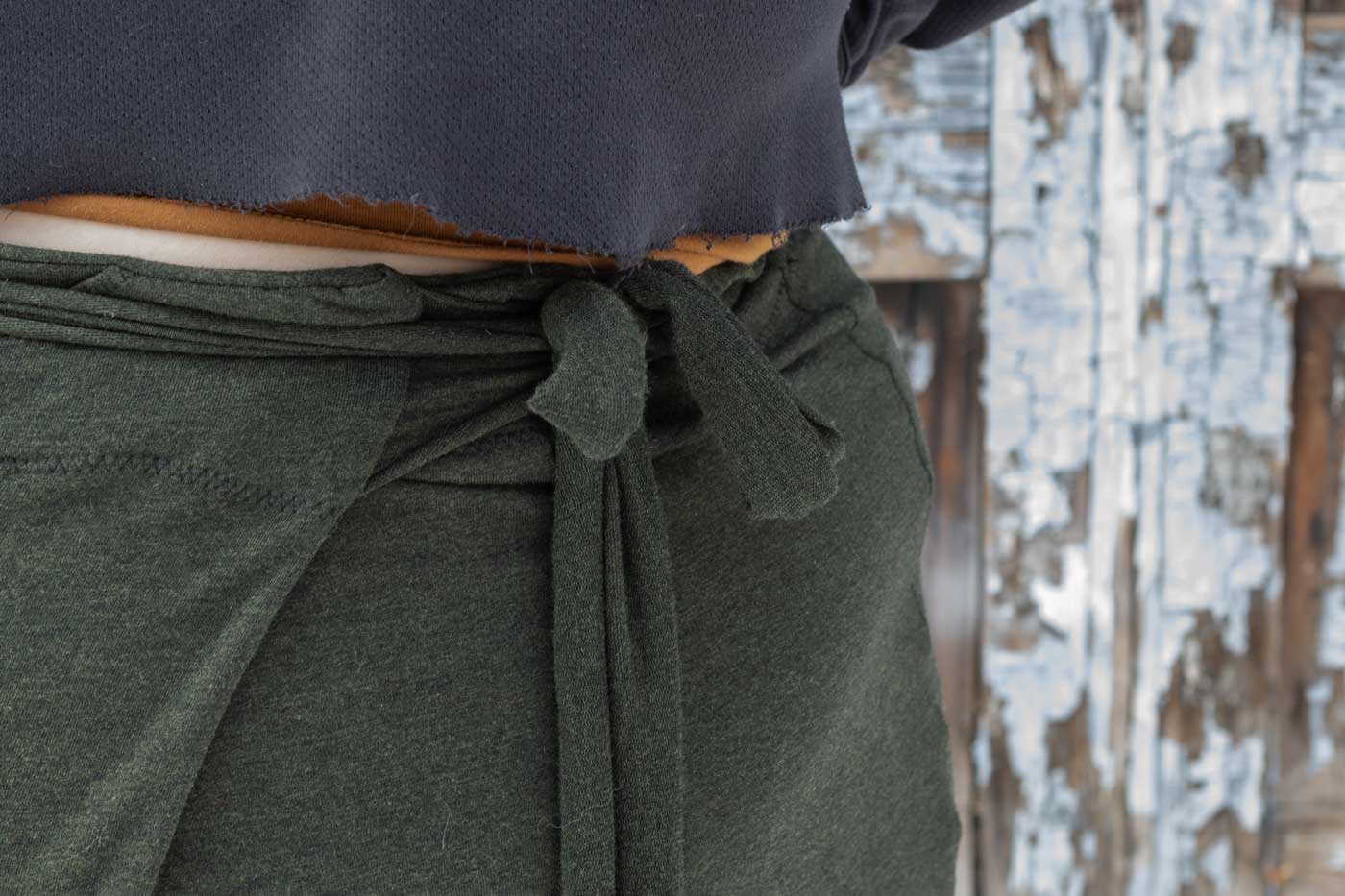 This is an image of a close up of Marta's Papao Wrap Pants focused on the wrap detail on the waist band.