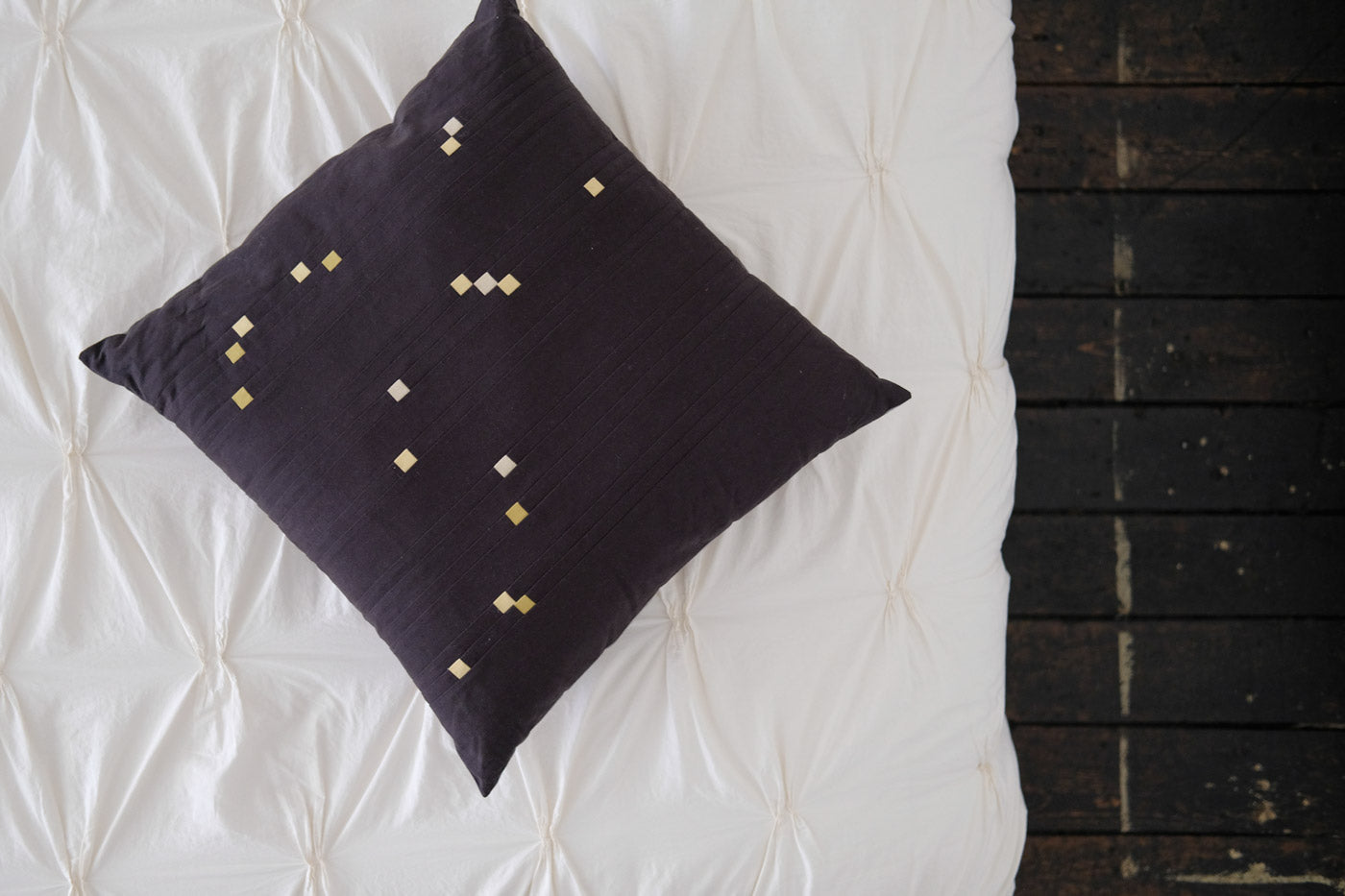 Orion Pillow on a white bed looking from above