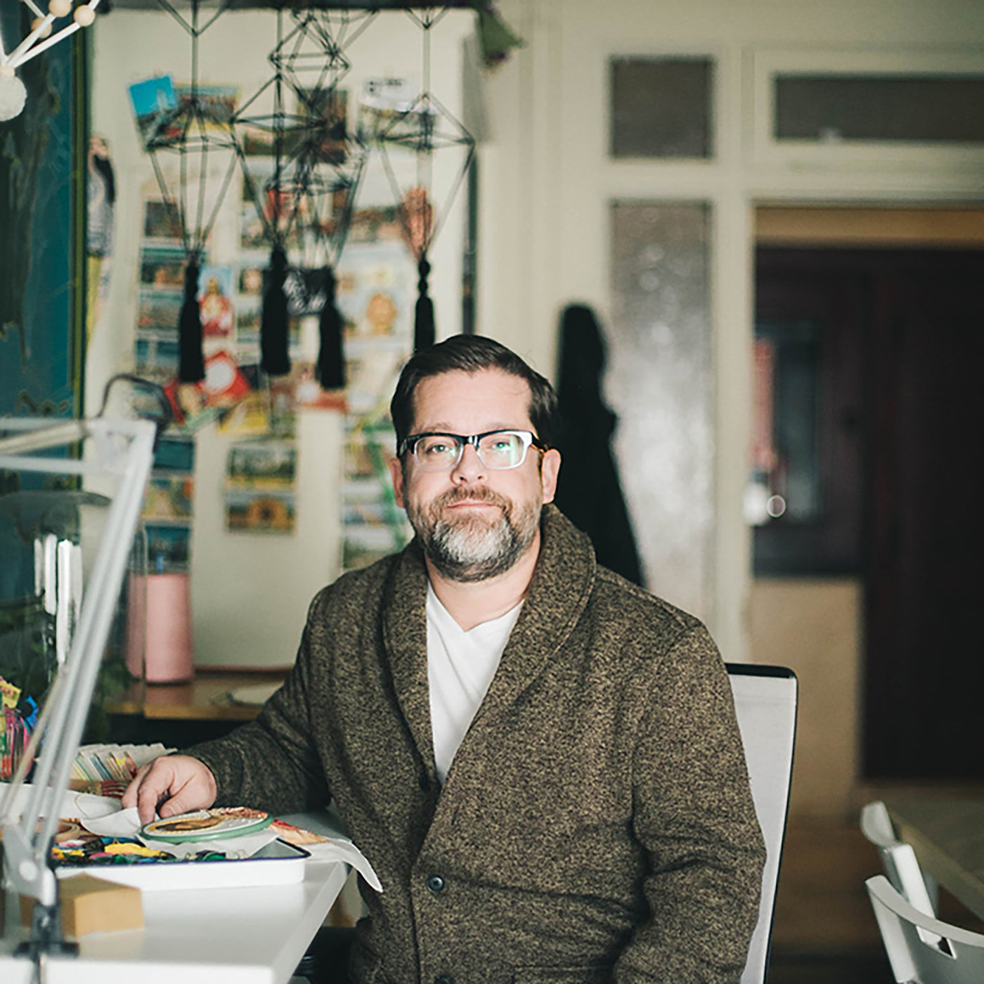 This is an image is Robert Mahar sitting in his studio