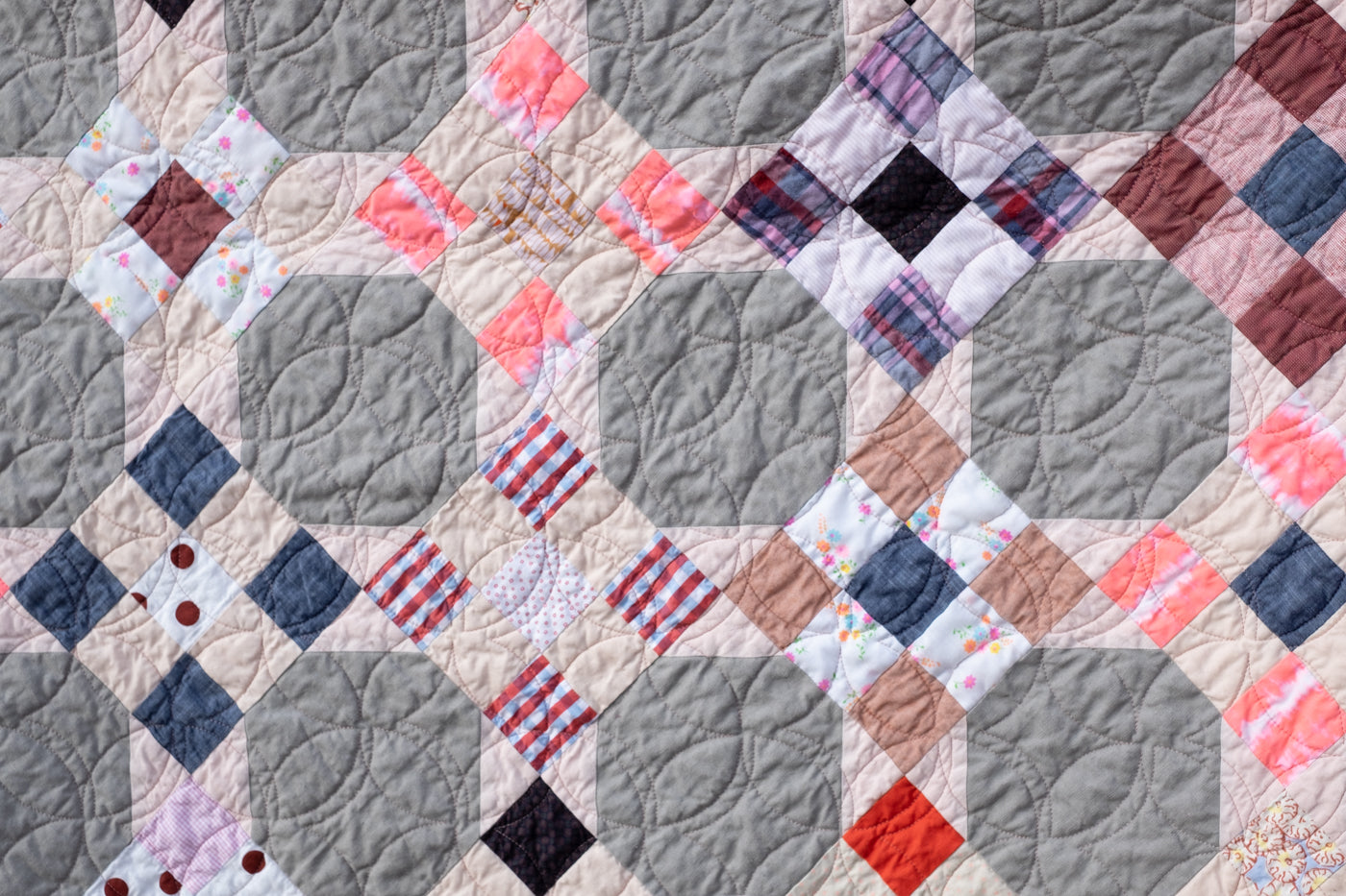 Up close photograph of scrap fabric quilt.