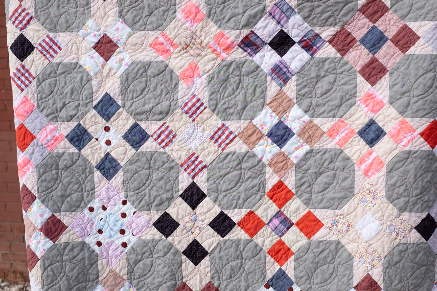 Photograph of scrap quilt up close in detail.