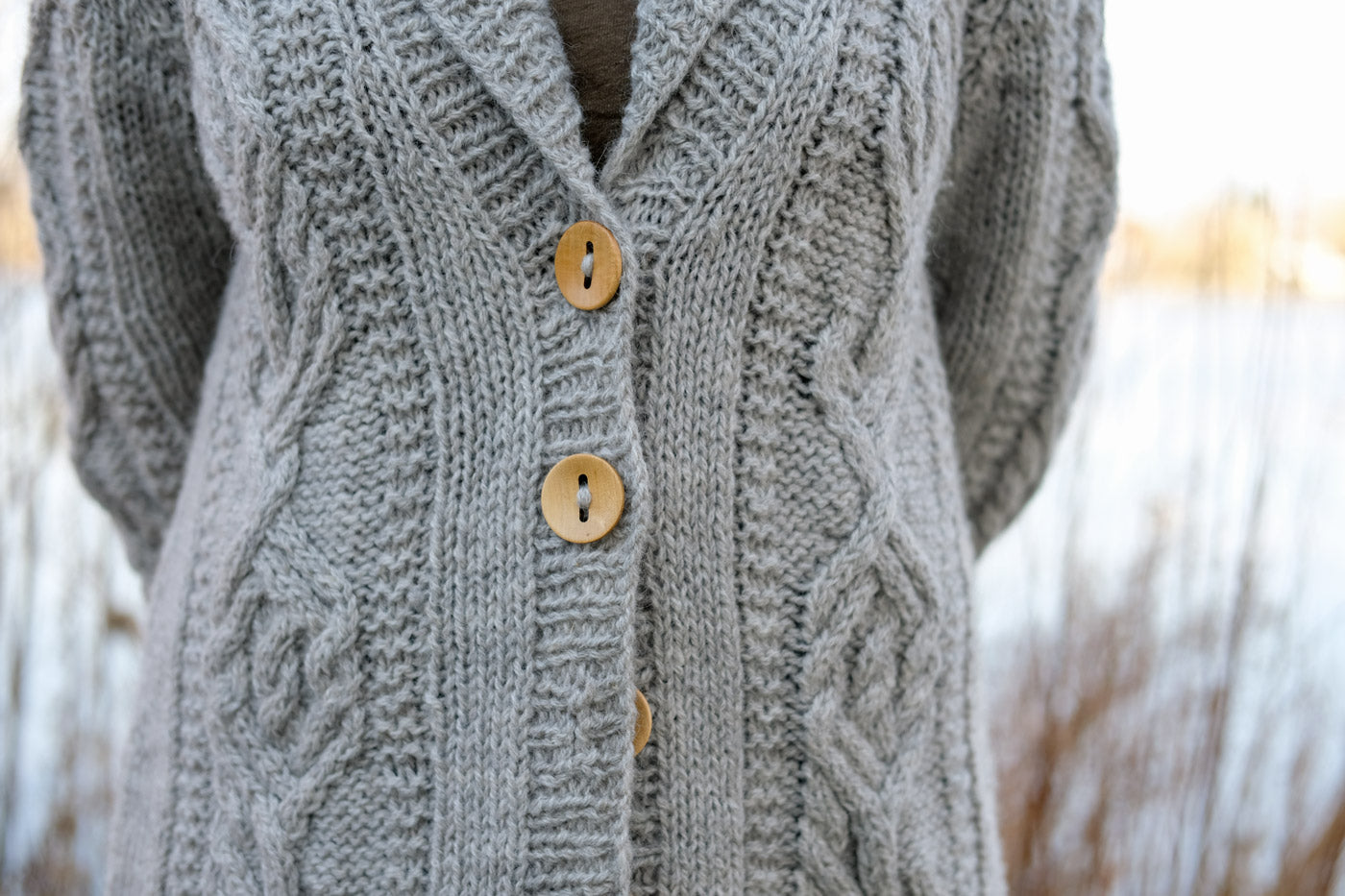 Close up of the oversized collar and button band of Amber's Jungrass Sourcebook Cabled Cardigan