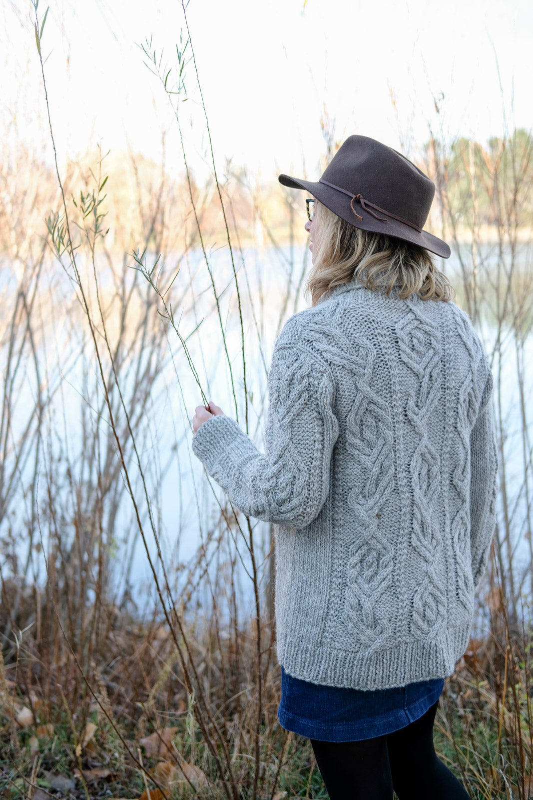 Amber by the water in her cabled Junegrass Cardigan