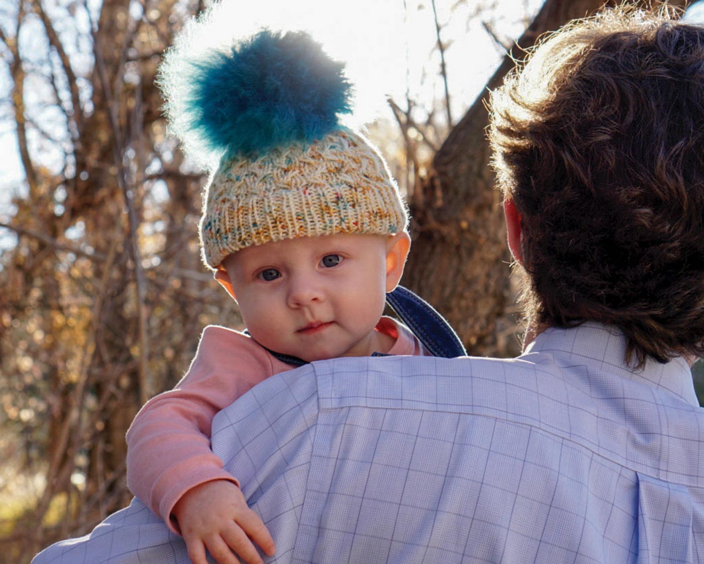 Baby in pom pom hat