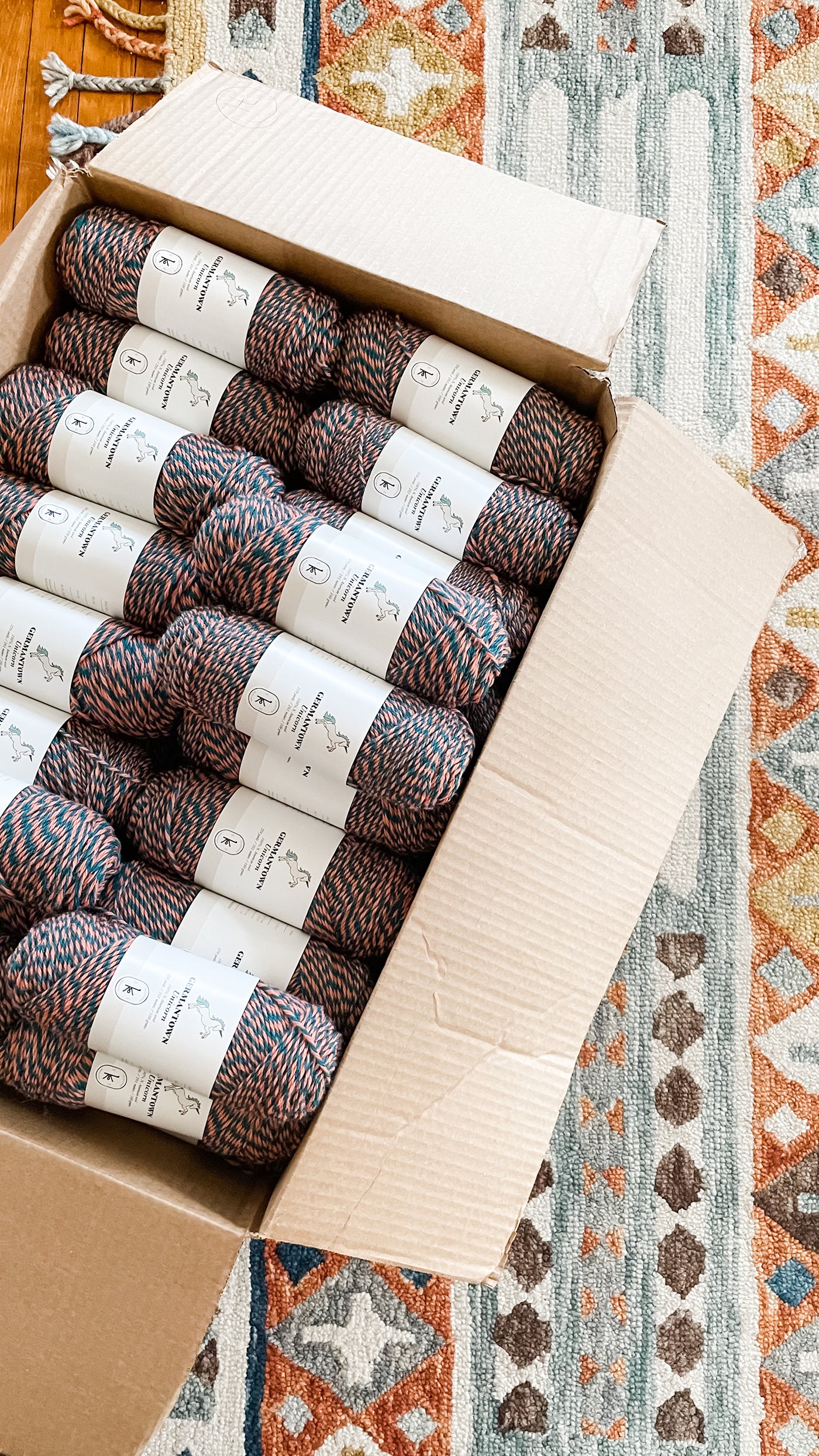 This is an image of a cardboard box full of skeins of yarn. 