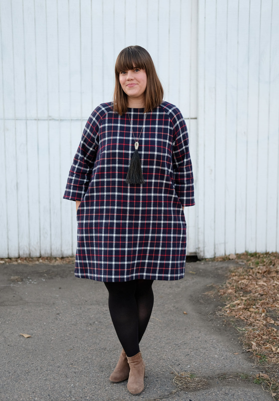 Kaylee standing with her legs crossed and hands in the pockets of the Avid Seamstress Raglan Dress