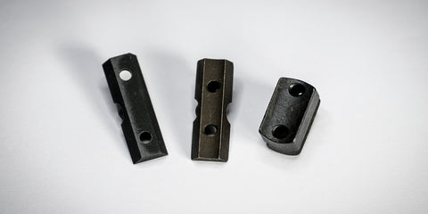 The underside of different blocks, showing the shape of their mounting point