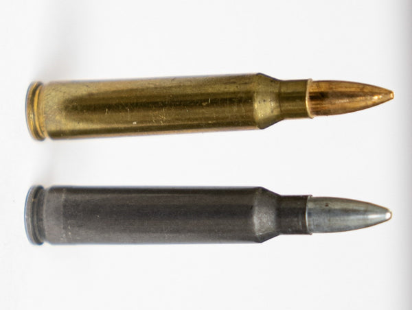 A brass and a steel cased .223 rem round
