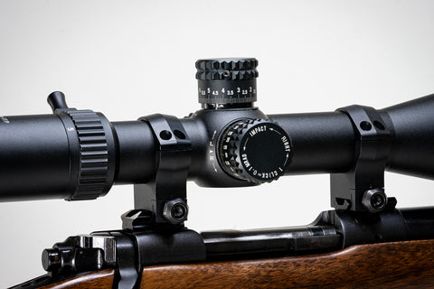 a scope mounted on a rifle, emphasizing the turret block