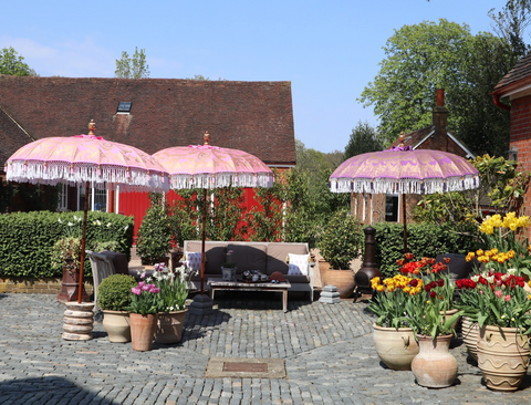 3 pink parasols in garden