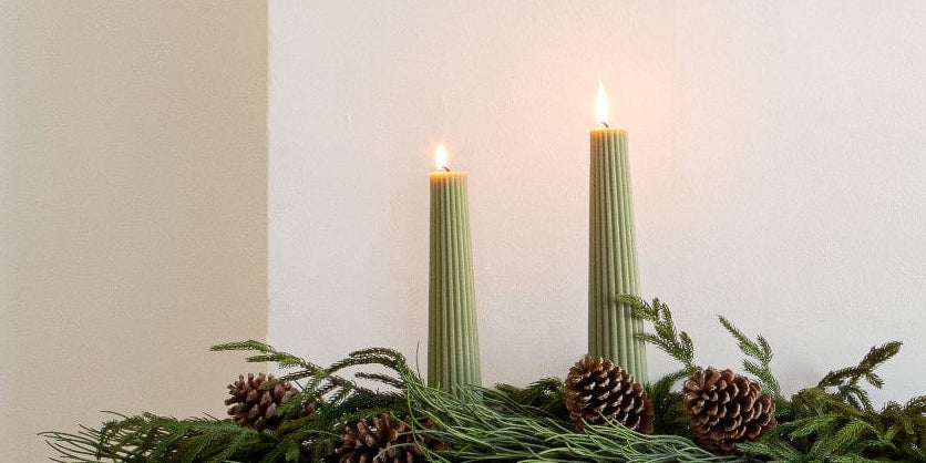 Close up of Green Pillar Candles. | Afloral