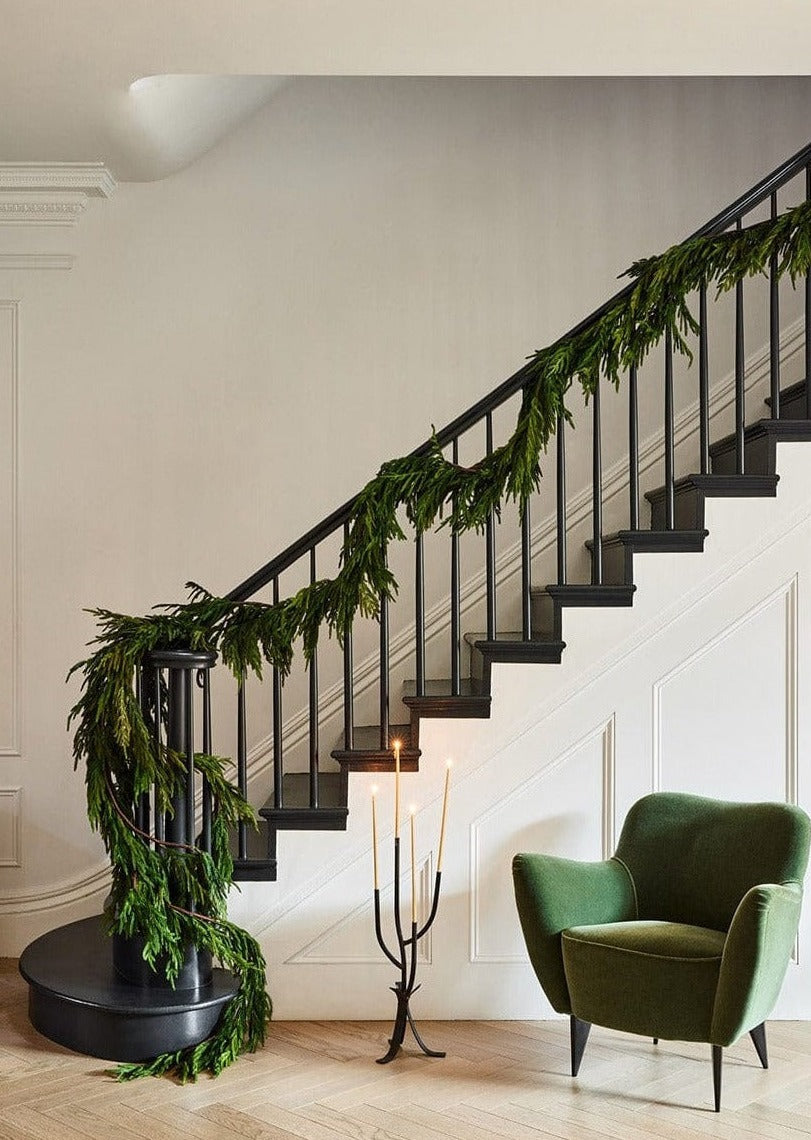 afloral faux norfolk pine garland on stair banister