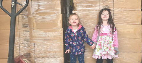 Children in front of boxes for charity donation