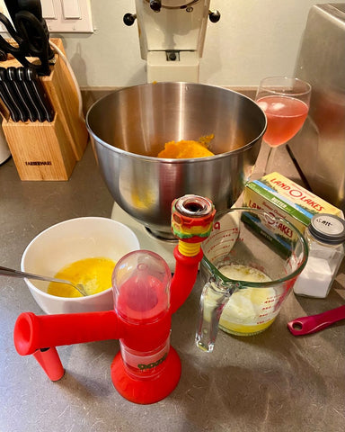 The Scarlet Ooze Cranium Hybrid Water Pipe is packed and being smoked while someone is baking. There is a big stand mixer with stuff in the bowl, and several other bowls around the mixer with ingredients.