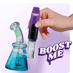 The purple galaxy Booster is being inserted in a blue Glyco Freeze bong to be used as a torchless dab rig