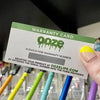A white female hand is holding an Ooze warranty code with the scratch-off section still covering up the code