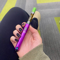 A girl with black nails holds her purple Ooze Smart Battery with an OozeX 510 oil cart attached