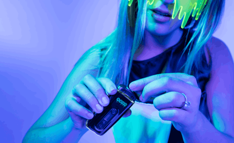 A blonde girl wearing a neon green slime mask is filling an Ooze Flare with dry herbs.