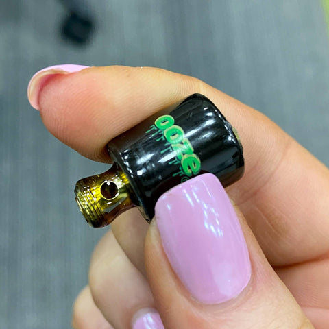 Holding a dirty Onyx Atomizer to show the sticky concentrate residue on the threads.