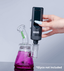 A black Ooze Verge is inserted to a purple Glyco freeze pipe with the water pipe adapter