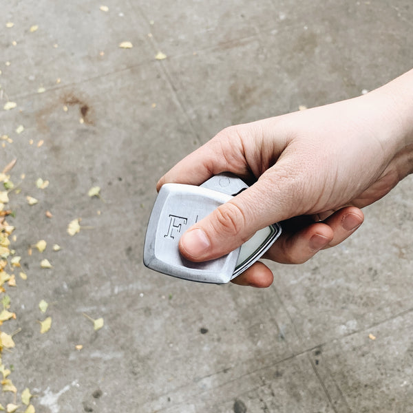 Image of hand swiveling open a Fulton & Roark solid cologne/fragrance