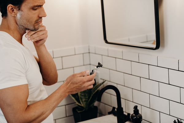 Image of man with shave cream on his face getting ready to shave