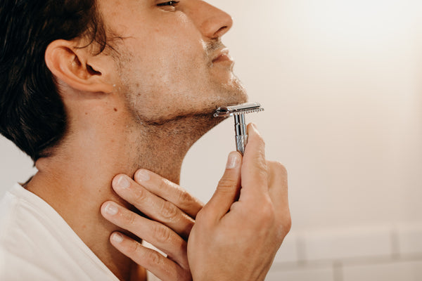 Image of a model shaving his face