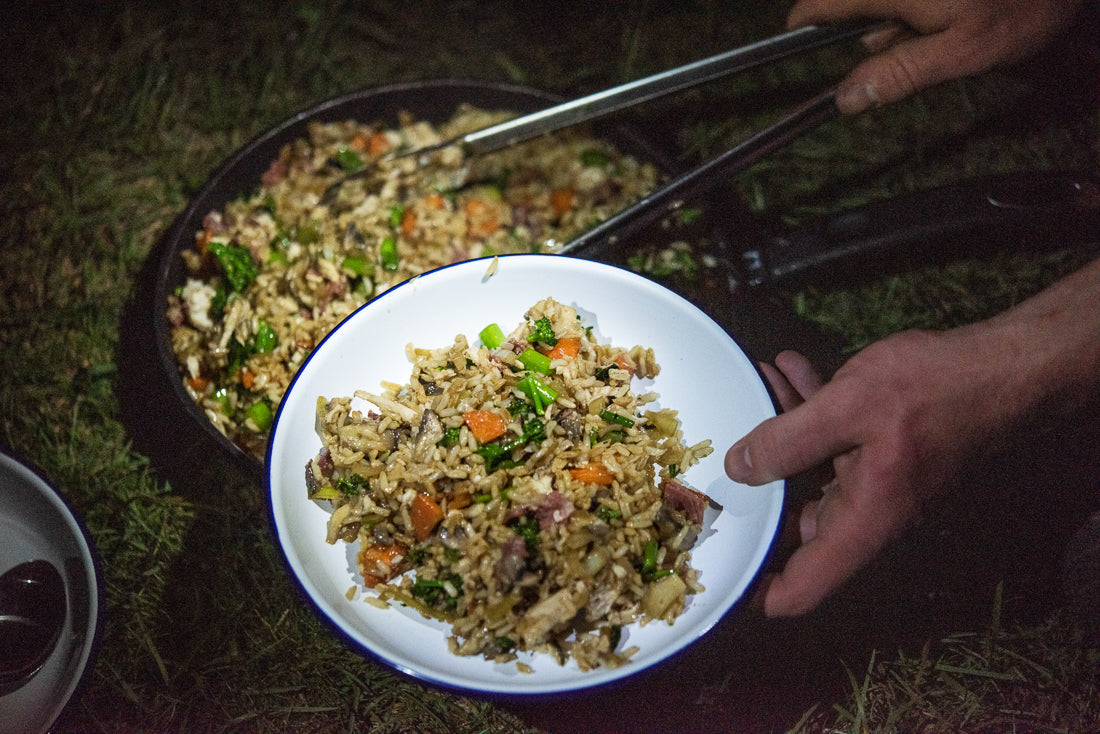 Fried rice cooked on the Snow Peak Pack & Carry Fireplace being served into a bowl