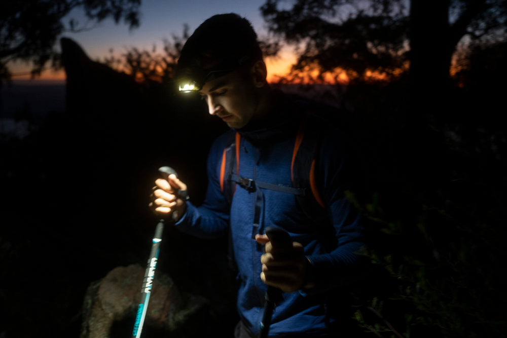 Trekking poles and head torch are helpful when walking down in the dark