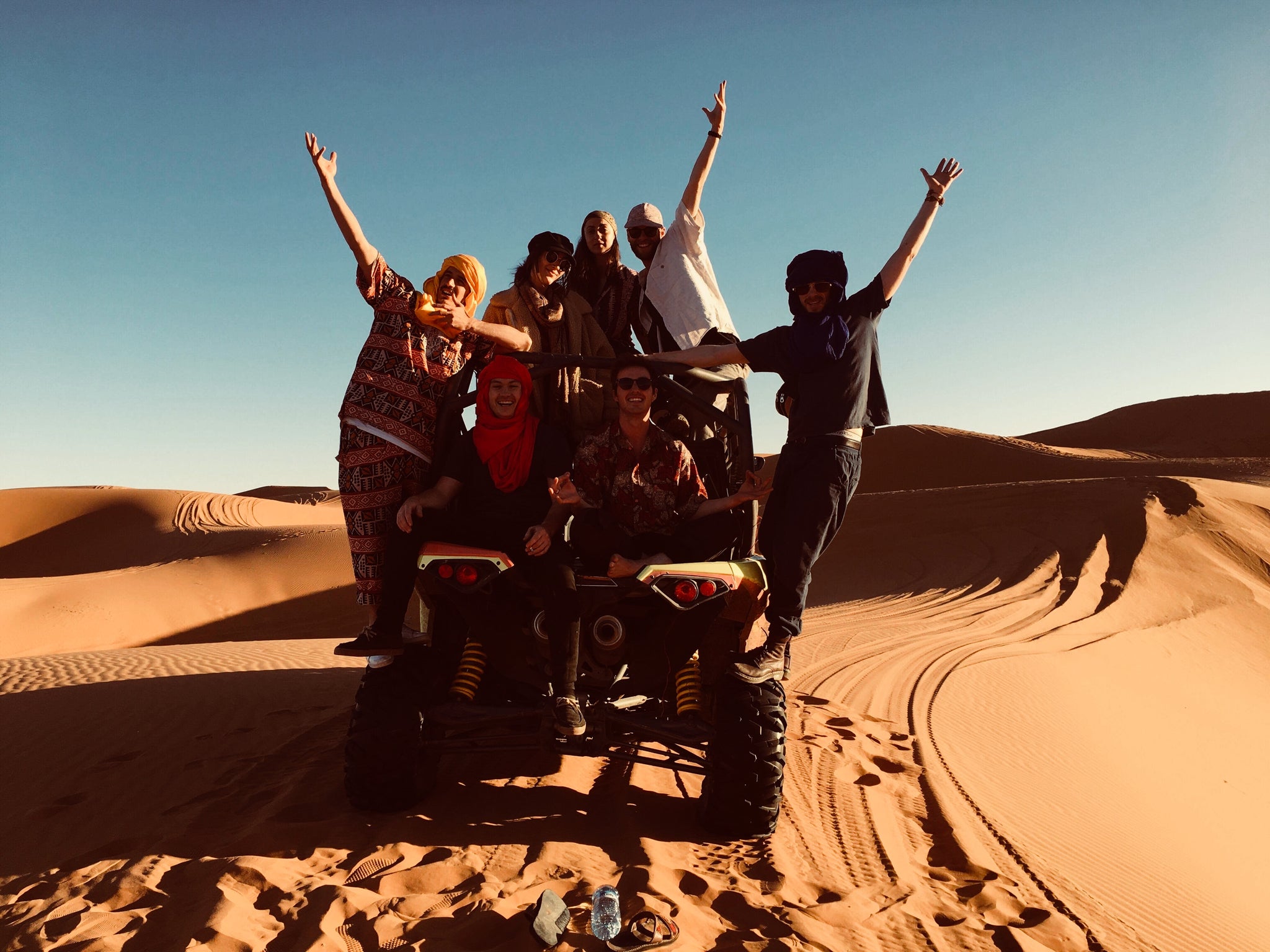 a group of friends on their buggy in the western sahara