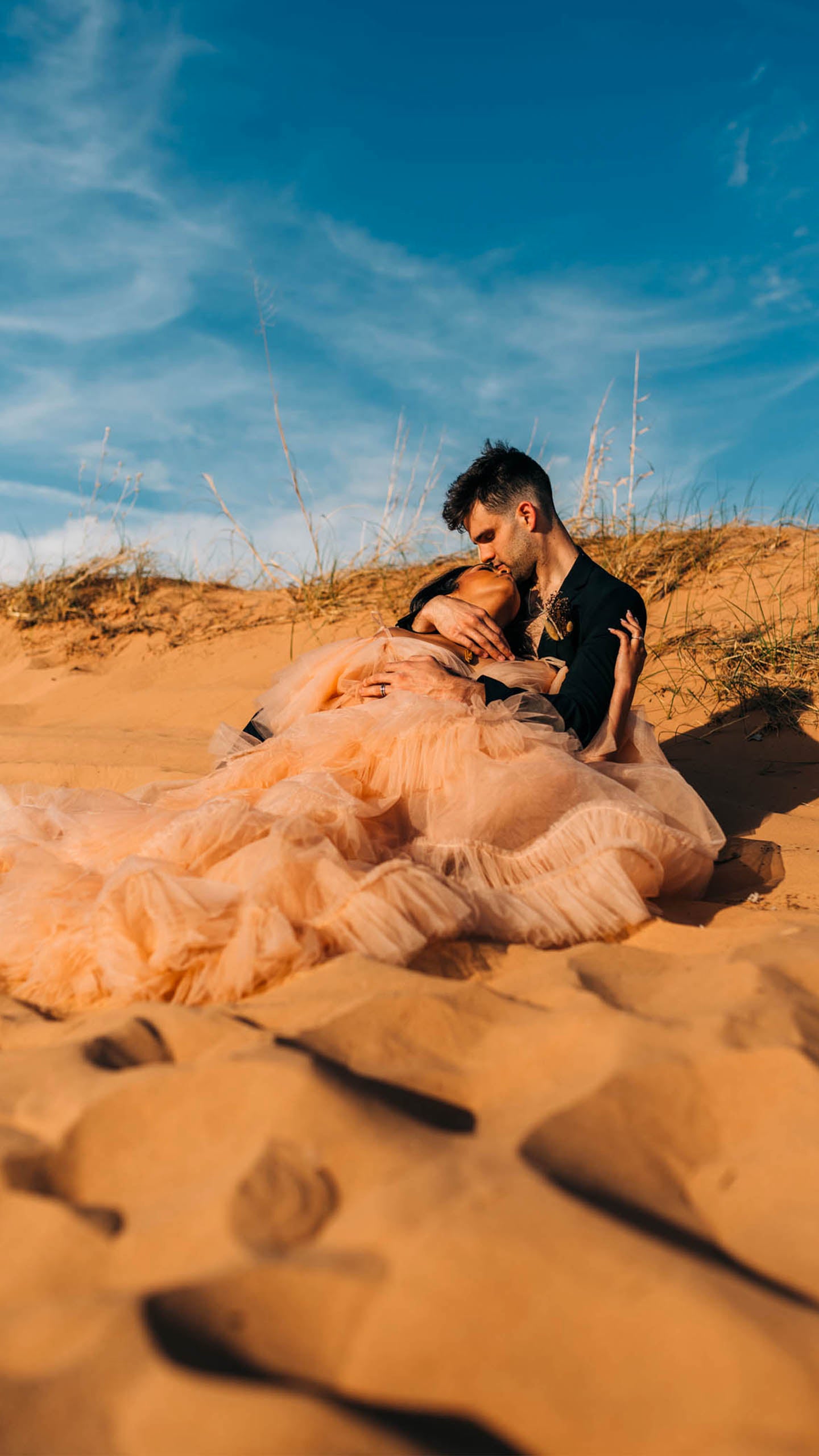 Bride and Groom holding each other on the desert Joshua tree wedding