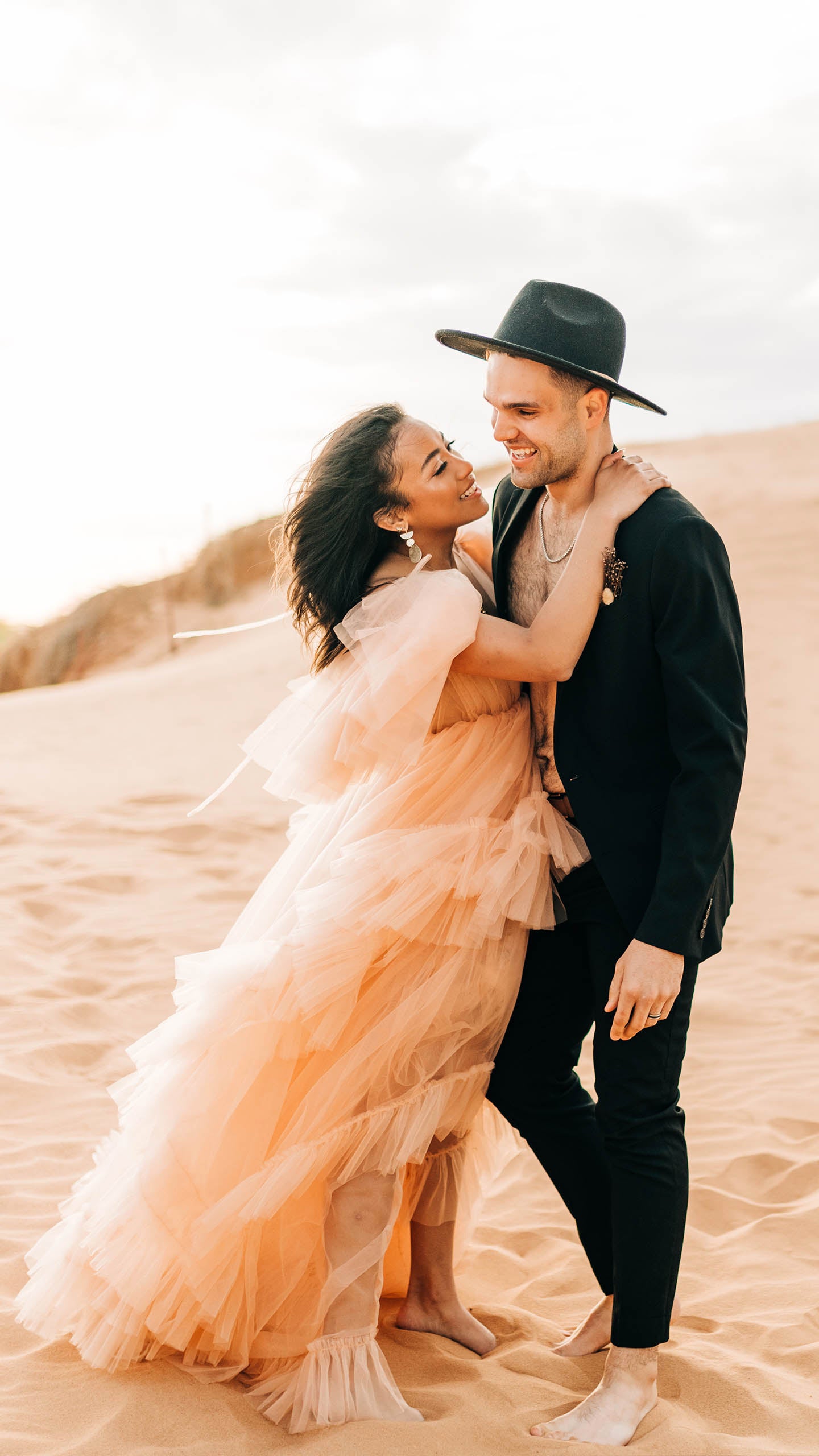 Bride and Groom walking in the desert joshua tree boho hipster utah wedding