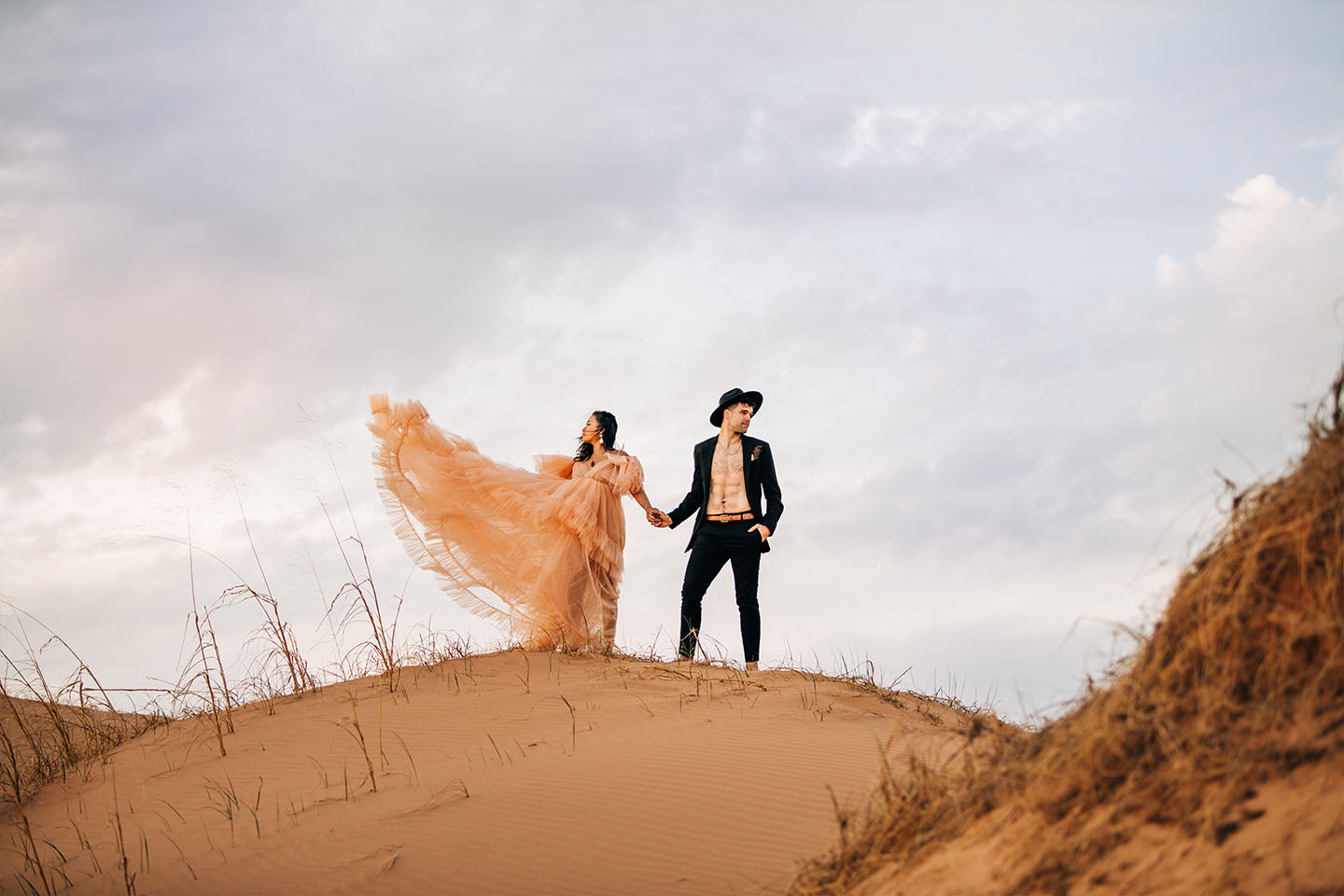 Bride and Groom in the desert on sand dune in joshua tree boho hipster utah wedding