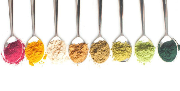 LiveBrine flavored with superfood powders shown on spoons