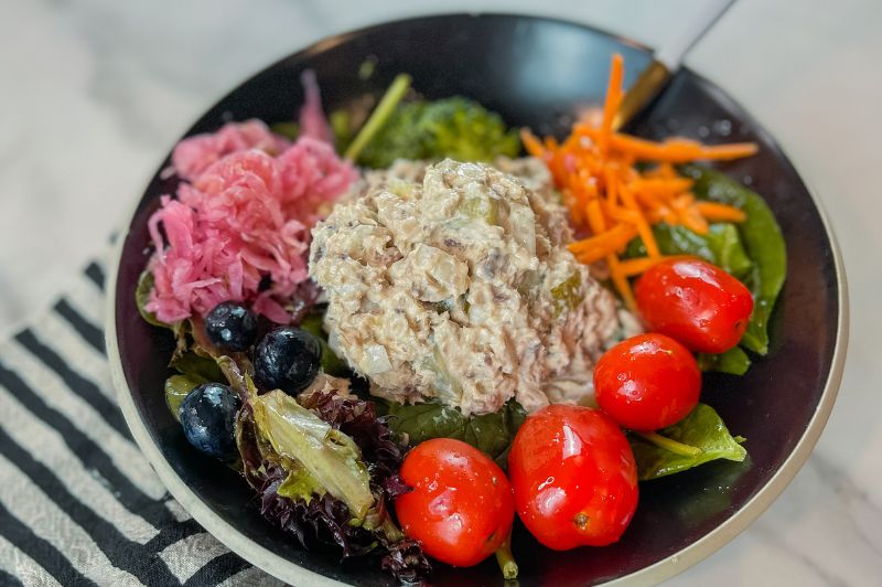 OMP sardine salad pictured in bowl with greens and veggies