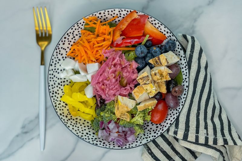 colorful kitchen sink salad with kraut and olives