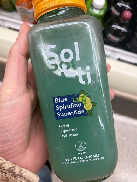 Holding bottle of Sol in grocery store