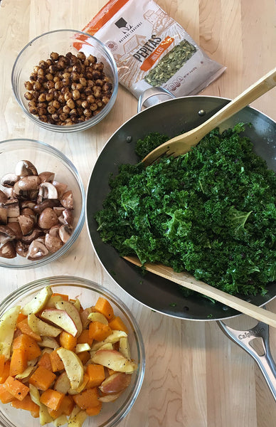 Bowls of kale, potatoes, muchrooms, chickpeas, and pepitas