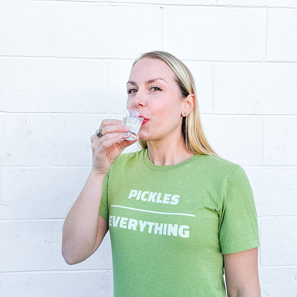 girl drinking a shot of pickle juice for hydration