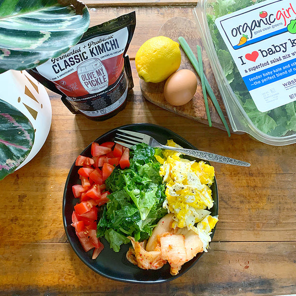 Plate of greens with eggs and Kimchi